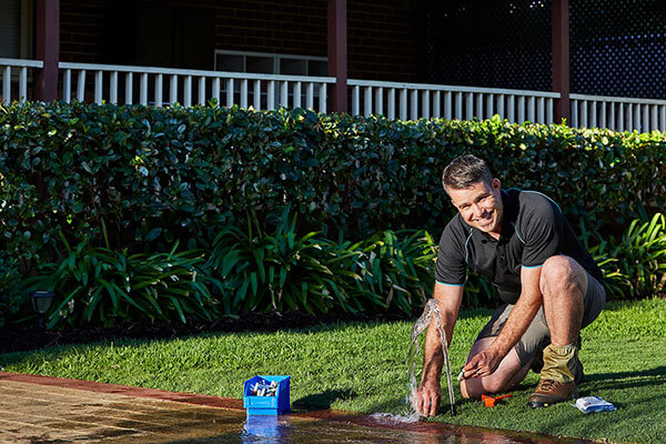 Luke Porter fixing a broken sprinkler