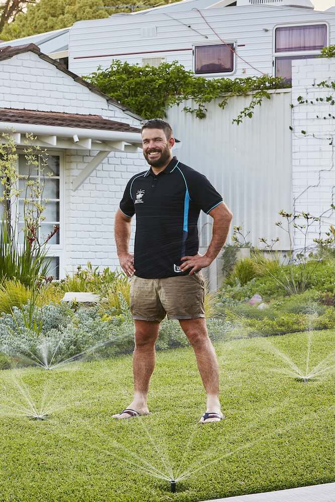 Luke in a green garden after a retic repair in Perth